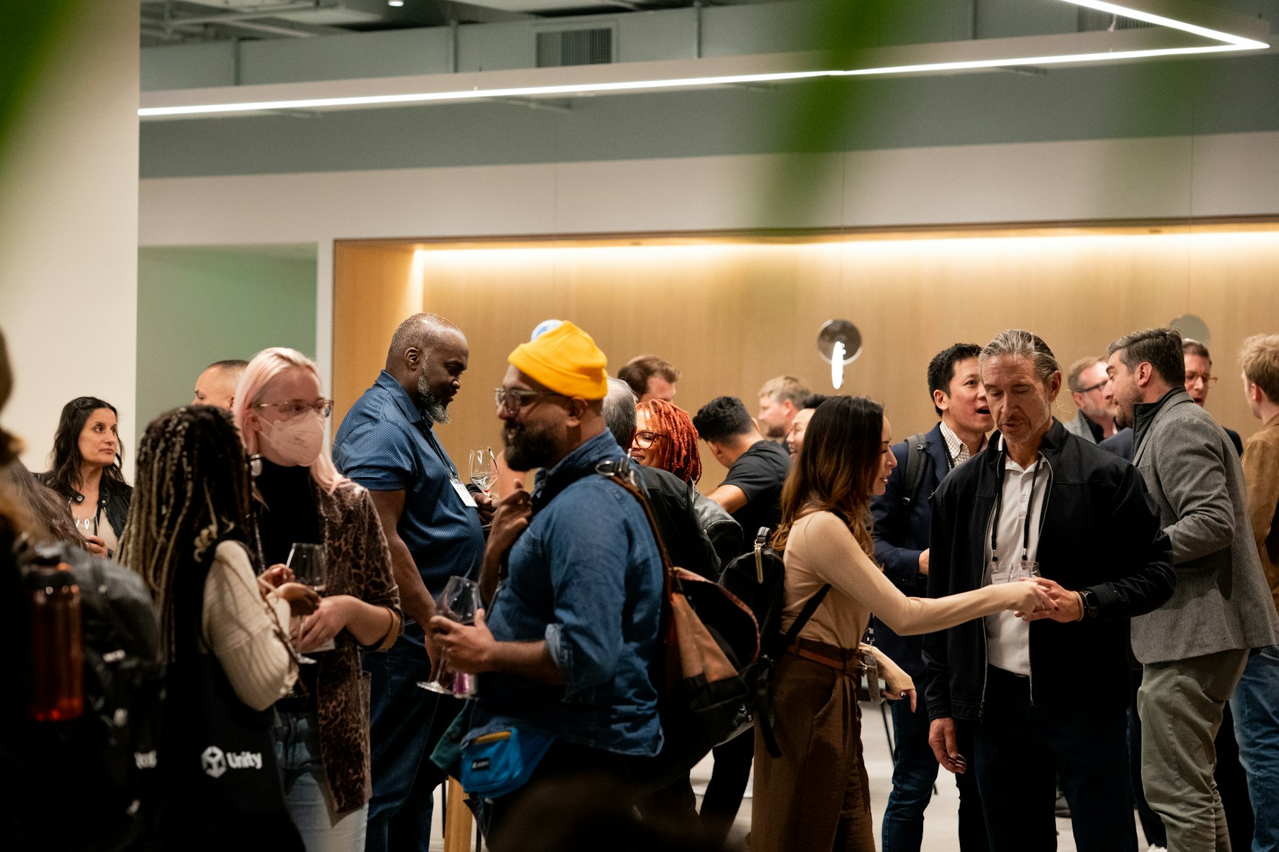 People having warm in-person conversations at a social event